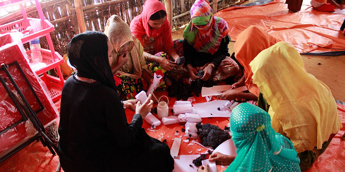 Refugee girls making handicrafts for younger children in the Child Friendly Spaces (CFS)